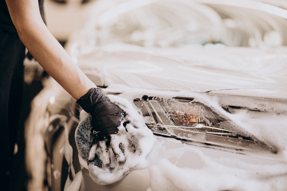 Verified car detailer washing a vehicle