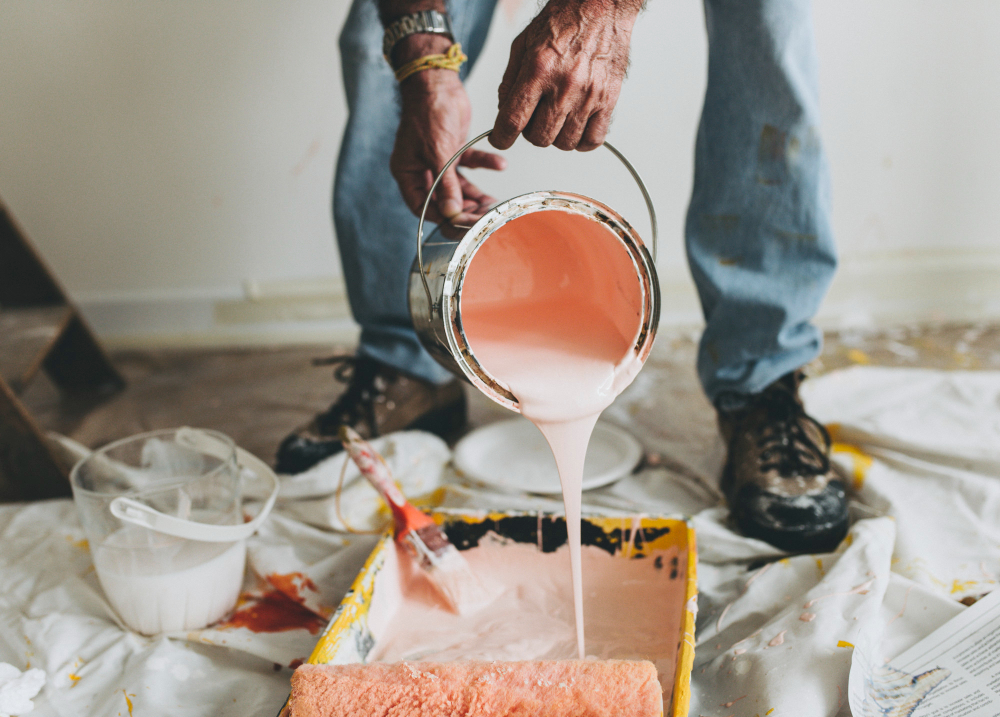 Verified painter pouring paint